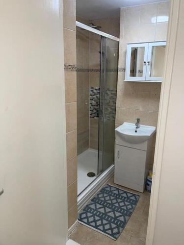 a bathroom with a shower and a sink at room with share bathroom Near train line in London