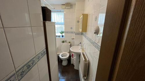 a small bathroom with a toilet and a sink at Stunning 3-Bed Apartment in Croydon in Croydon