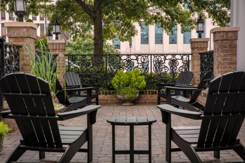 a group of chairs sitting on a patio at Candlewood Suites Mobile-Downtown by IHG in Mobile