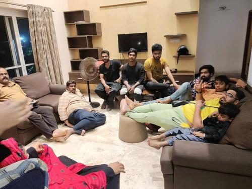 a group of people sitting in a living room at Olive Villa ECR 3BHK with Swimming Pool in Chennai