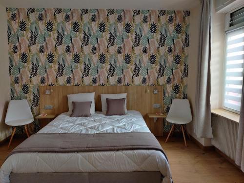 a bedroom with a bed with two tables and a curtain at cocon des lys in Saint-Louis