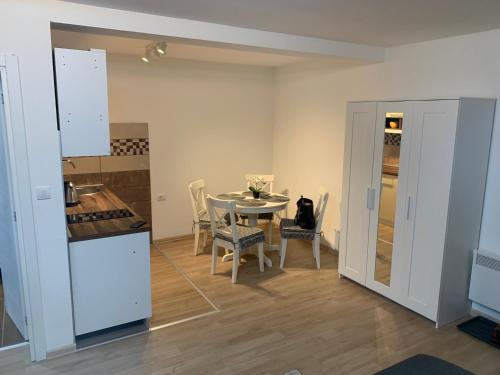 a kitchen and dining room with a table and chairs at Studio Mila in Nova Varoš