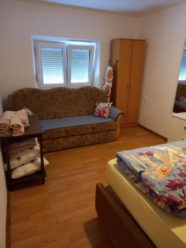 a living room with a couch and a bed at Apartman Duman in Livno