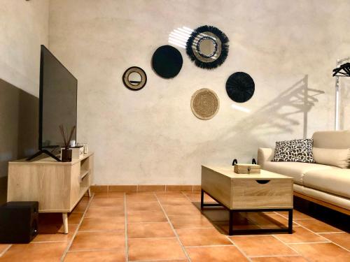 a living room with a couch and a table at Domaine Plan des Devens in Roussillon