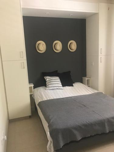 a bedroom with a bed and two plates on the wall at LE CAROUBIER splendid 3 bedrooms bungalow in Zanaja
