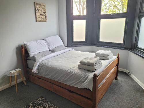 a bedroom with a bed with two towels on it at Arsenal and Tottenham Double Bedroom in London