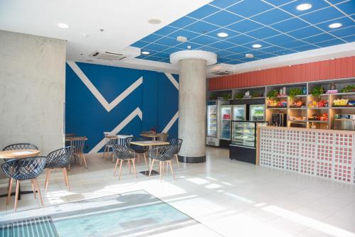 a restaurant with chairs and tables and a blue ceiling at ibis budget Rio de Janeiro Centro in Rio de Janeiro