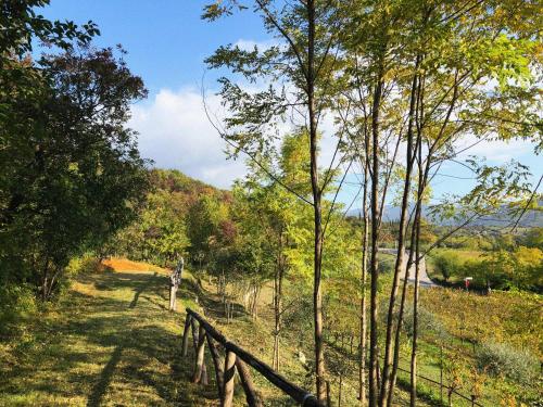 a wooden fence in a field with trees at Agriturismo Ca' Cristane in Rivoli Veronese