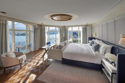 a large bedroom with a large bed and windows at Mandarin Oriental Palace, Luzern in Luzern