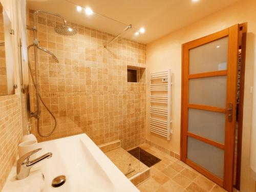 a bathroom with a shower and a sink at La Grange de Marie à St Angel - Magnifique Grange Rénovée en loft pour 1 à 6 pers in Saint-Angel