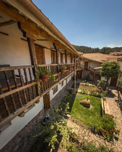 an old house with a courtyard with potted plants at El Balcón in Cusco