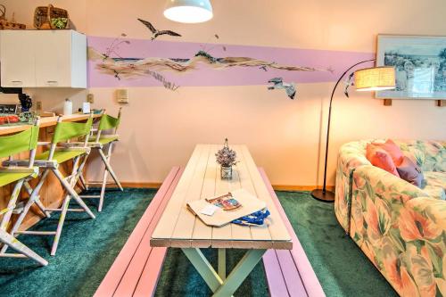 a living room with a table and a couch at Kitty Hawk Townhome at Sea Dunes - Walk to Beach! in Kitty Hawk