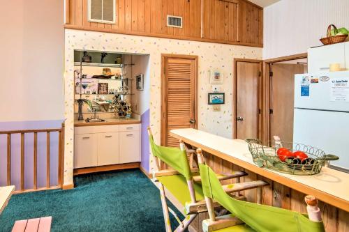 a kitchen with a table and green chairs at Kitty Hawk Townhome at Sea Dunes - Walk to Beach! in Kitty Hawk