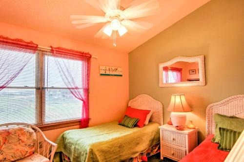 a bedroom with two beds and a mirror and a window at Kitty Hawk Townhome at Sea Dunes - Walk to Beach! in Kitty Hawk