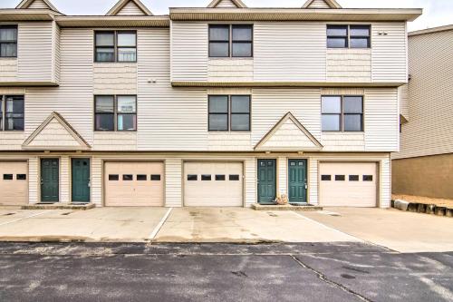 a large white building with four garage doors at Kitty Hawk Townhome at Sea Dunes - Walk to Beach! in Kitty Hawk