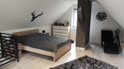 a bedroom with a bed and a window at Dobry Dom I in Staszów