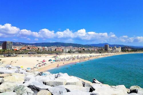 a group of people on a beach near the water at VILLA VALENTINA in Mataró