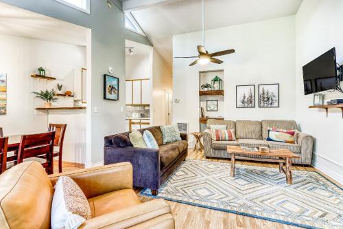 a living room with couches and a ceiling fan at Sun River Retreat in Sunriver