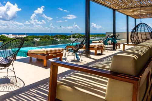 プラヤ・デル・カルメンにあるBig Studio at KAAB BY THE BEACH with roof top pool, sauna and Jacuzzi near Paseo del Carmen Mallのデッキ(椅子付)、スイミングプール