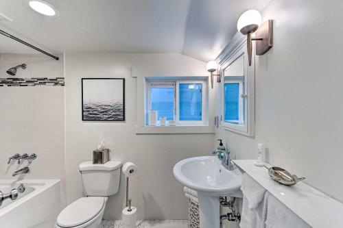 a white bathroom with a sink and a toilet at Queen Anne Cottage Near Restaurants and Stadiums! in Seattle