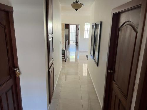 a hallway with two doors and a hallwayngth at Villa Caterina in Dajabón