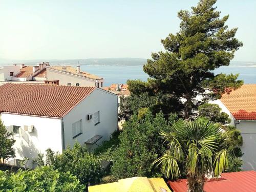 a view of a city with a tree and buildings at Villa Dora Crikvenica ## in Crikvenica