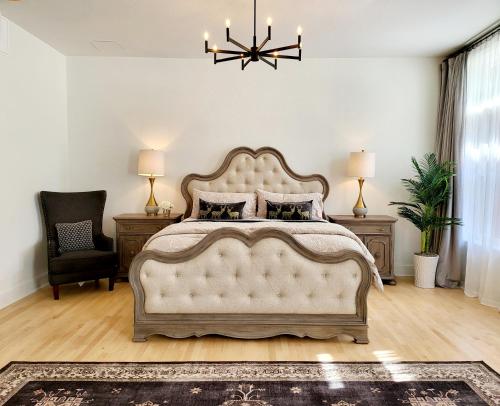 a bedroom with a large bed and a chandelier at The Bank Hotel Deadwood in Deadwood