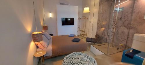 a room with a bedroom with a bed and a shower at Loft 19 in Turin