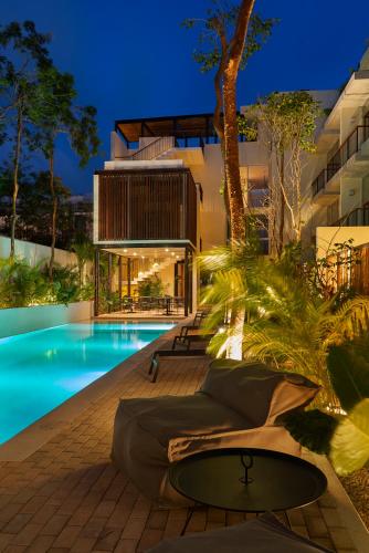 a house with a swimming pool at night at Private pool and rooftop for 3 in Tulum