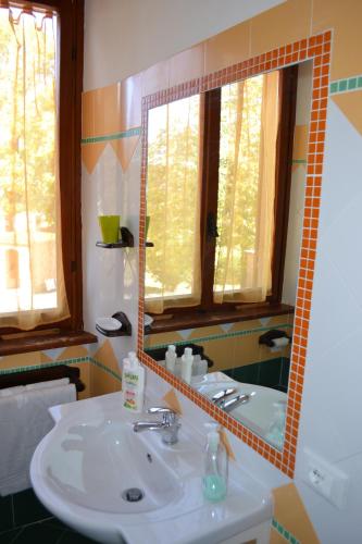 a bathroom with a sink and a mirror at Agriturismo Le Forre del Treja (La Villa) in Civita Castellana