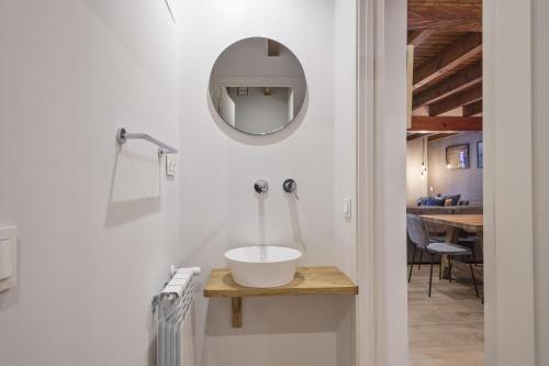 a bathroom with a sink and a mirror on a wall at Luderna - Casa Pleta de Arties Pruedo in Arties