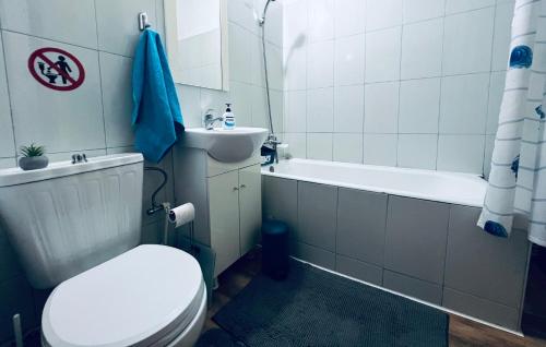 a bathroom with a toilet and a sink and a tub at Altheda Living Tineretului E8 in Suceava