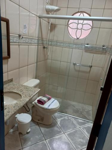 a bathroom with a shower and a toilet and a sink at Pousada Sinhá Moça Campos Ltda in São João del Rei