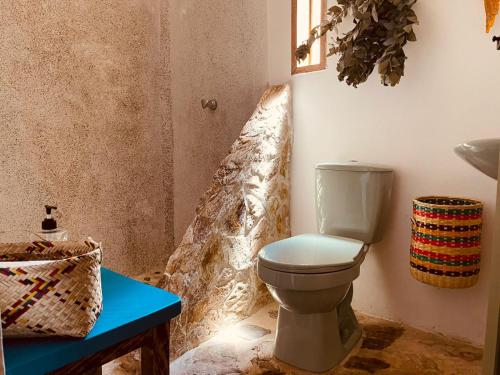 a bathroom with a toilet and a blue table at Casa de Campo - Hotel Desayuno Pizza Bar in Medellín