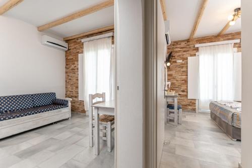 a bedroom with a bed and a table in a room at Agios Prokopios Hotel in Agios Prokopios