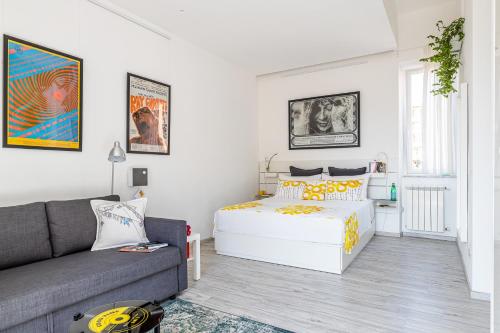 a living room with a bed and a couch at PIGNETO VILLAGE Roma Guest House Apartment in Rome