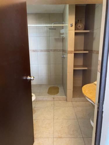 a bathroom with a shower with a glass door at Gran habitacion con terraza vista espectacular, piscina in Acapulco