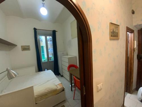 a room with a bed and a table and a mirror at Double Accomodation In San Frediano in Florence