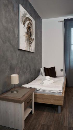a bedroom with a bed and a desk with a lamp at U Šípků in Ostrava