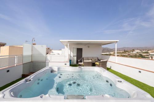 a hot tub on the roof of a house at Terraza Mar y Montaña in Nerja