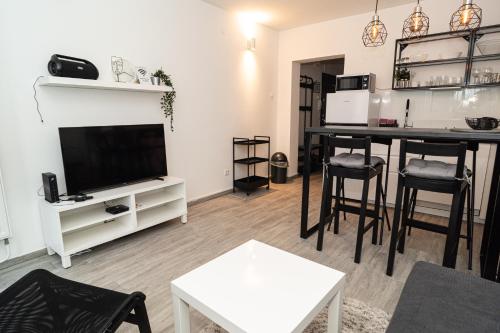 un soggiorno con TV e tavolo di Apartman Ina a Osijek