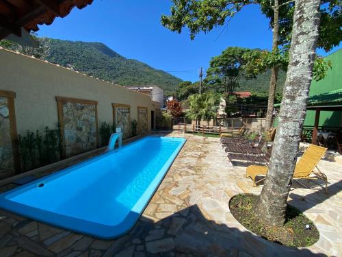 a swimming pool in front of a house at Pousada Bugio in Abraão