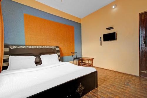 a bedroom with a large bed and a table at Hotel grand City heart in Srinagar