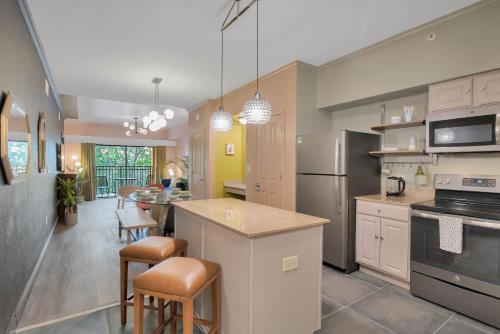 a kitchen with a counter and a dining room at Designer 3BR/2BA Corner Suite - Disney & Universal in Orlando