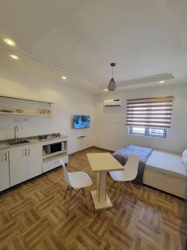 a bedroom with a bed and a table and chairs at Cozy Self-contained Serviced Apartment in Abuja