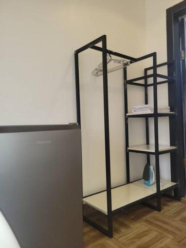 a black shelving unit in a room at Cozy Self-contained Serviced Apartment in Abuja
