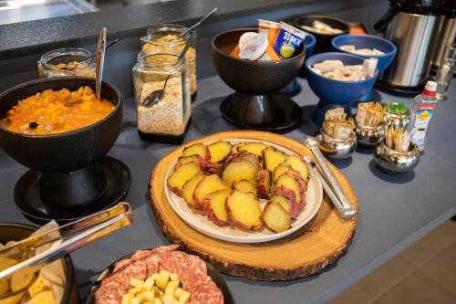 a table with a plate of food on a counter at Hotel Darolt Criciúma in Criciúma