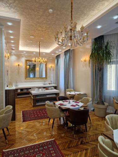 a dining room with a table and a piano at Queen Palace in Novi Sad