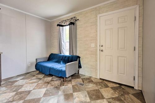 a room with a blue chair and a door at Pet-Friendly Cassopolis Escape with Lake Access in Cassopolis