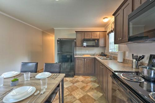 a kitchen with wooden cabinets and a table with plates on it at Pet-Friendly Cassopolis Escape with Lake Access in Cassopolis